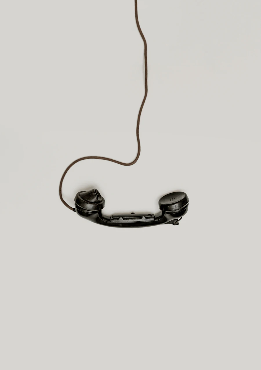 A telephone handset hanging off the hook